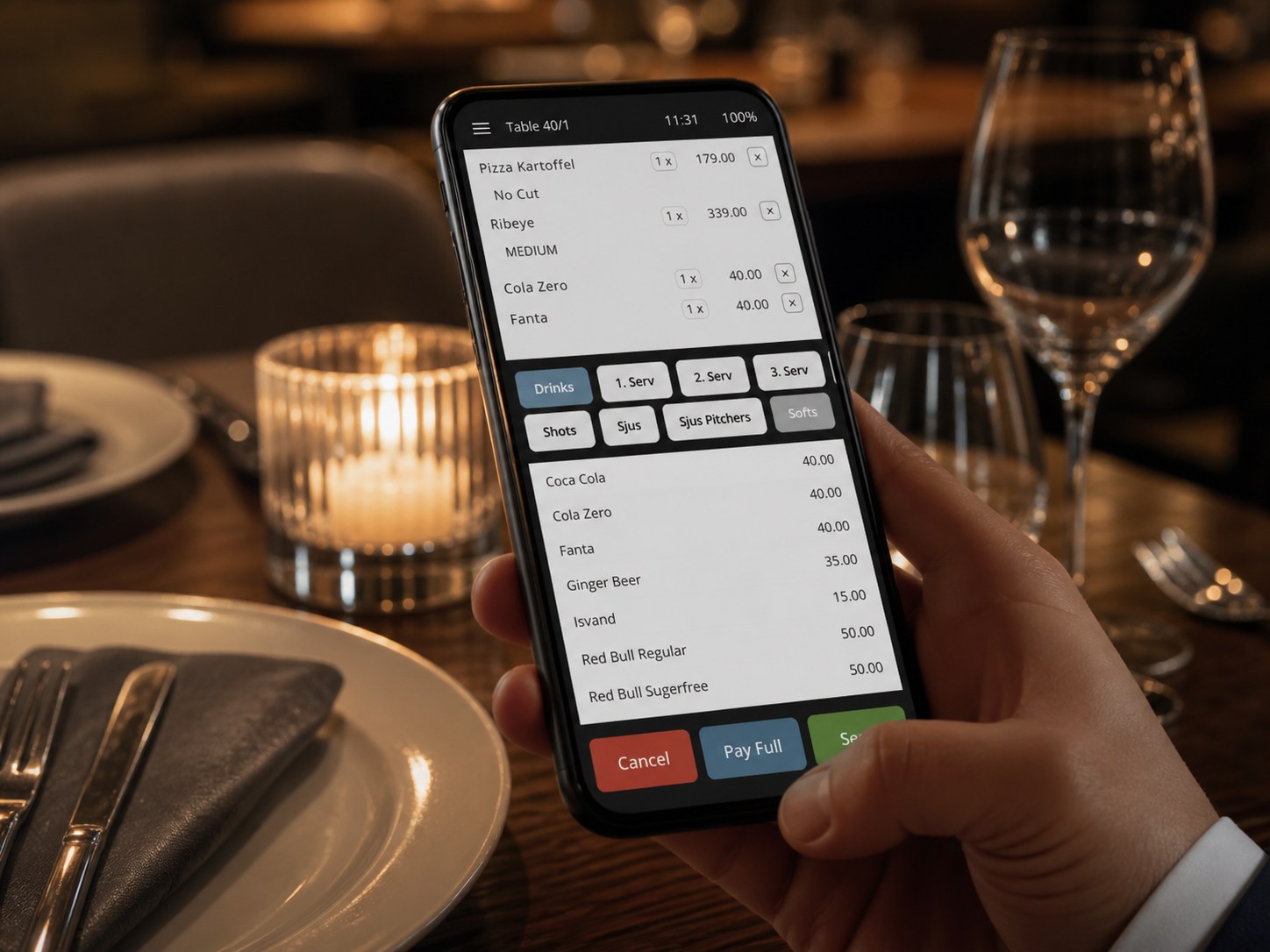Waiter entering an order on a mobile device at the table